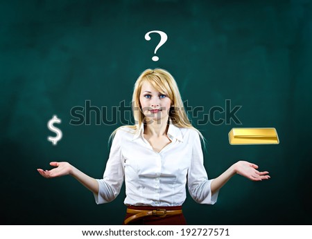 Closeup portrait young blonde, confused, puzzled business woman uncertain what safer investment decision to make, gold versus cash, dollars isolated green background. Financial opportunities, banking 