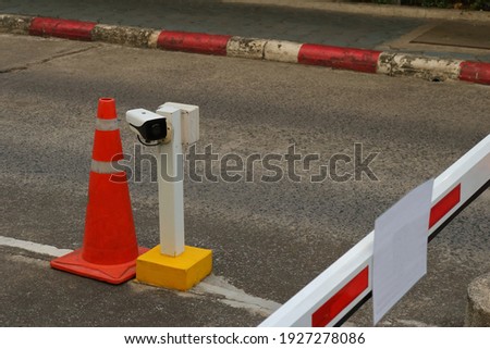 Closeup of security camera installed on upright post fixed to street at security checkpoint for vehicle 