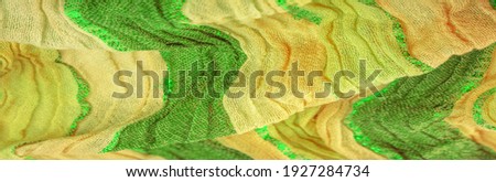 Silk fabric, large yellow-green stripes separated by a strip of emerald gold, pattern background texture, ornament