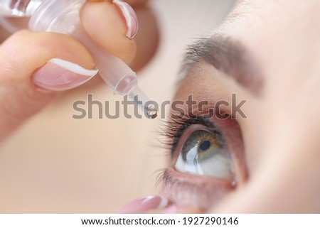 Woman drips eye drops into her eyes. Eye diseases and their treatment concept Royalty-Free Stock Photo #1927290146