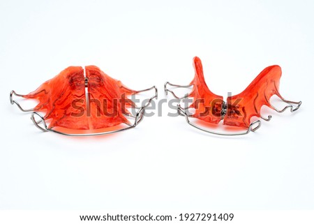 RETAINER AND REMOVABLE PALATAL EXPANDER. DENTAL APPLIANCES FOR CHILDREN'S ORTHODONTICS TREATMENTS. MOUTH HEALTH CARE CONCEPT. Royalty-Free Stock Photo #1927291409
