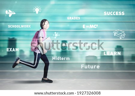 Double exposure of schoolgirl carrying a laptop and backpack while running fast inside binary code with cityscape background
