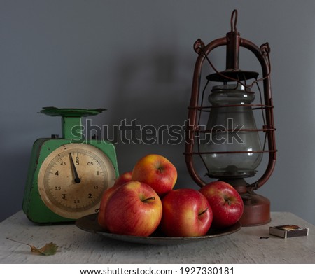 Still life with ripe apples, scales and a kerosene lamp. Vintage. Retro.