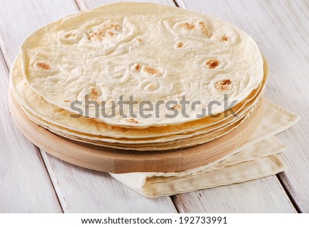 Wheat Flour Tortillas on wooden board. Selective focus