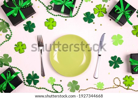 Festive table setting for St.Patrick's day with cutlery and lucky symbols on white table. Copy spase, top view.