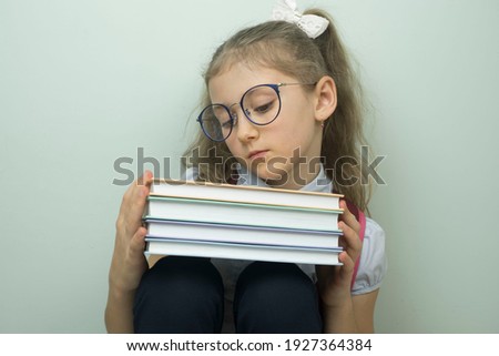 Portrait of smiling school girl child with school bag and books isolated on a white background education concept