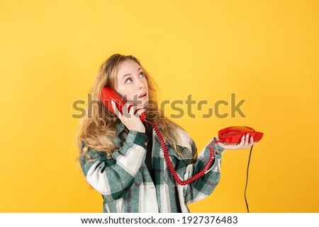 pretty blonde woman using mobile phone yellow tones