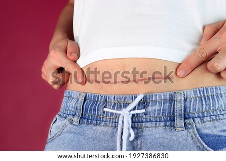 Woman showing the stomach with the scar of caesarean section Royalty-Free Stock Photo #1927386830