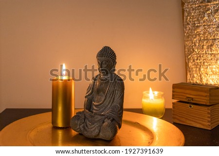 Spirituality atmosphere background with a Buddha statue. Candles Royalty-Free Stock Photo #1927391639