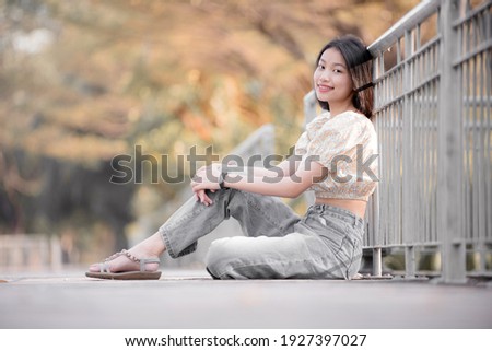 Lifestyle image of beautiful Asian woman. Park leisure concept.