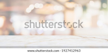 marble table top with blurred abstract cafe restaurant interior background Royalty-Free Stock Photo #1927412963