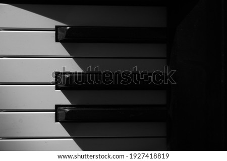 piano keys, play of light and shadow, abstract background music