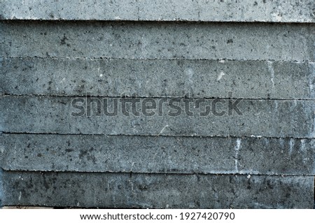 Gray concrete wall, old surface with peeling plaster. Building board texture. Vintage background close-up
