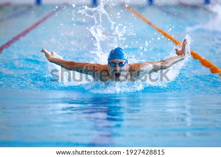 male professional competitive swimmer in swimming pool Royalty-Free Stock Photo #1927428815