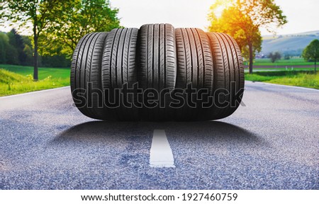 summer car tires on the street outside Royalty-Free Stock Photo #1927460759