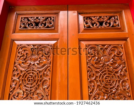 The Chinese temple has beautiful carved wooden windows.