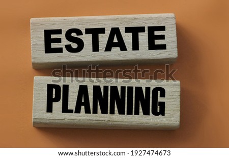 Estate planning words on wooden blocks on yellow. Real esate business concept.