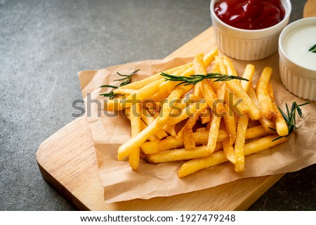French fries or potato chips with sour cream and ketchup Royalty-Free Stock Photo #1927479248