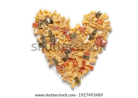 
heart made from alphabet pasta on white background Royalty-Free Stock Photo #1927493489
