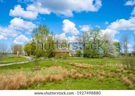 Beautiful countryside landscape view with a farmstead Royalty-Free Stock Photo #1927498880