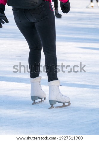 Attractive woman  ice skating on the ice rink from Cismigiu park, in Bucharest