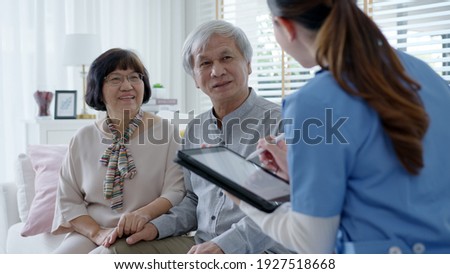 Young asia female nurse, assisted living, in-home carer or doctor visit old senior citizen at home talk about result follow up checklist, health care advice or prescription online on tablet computer. Royalty-Free Stock Photo #1927518668