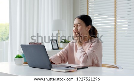 Attractive beautiful young asia female feel tired overworked negative impact health life stretching for break time relax stress relief in concept problem work remotely from home or burnout syndrome. Royalty-Free Stock Photo #1927521296