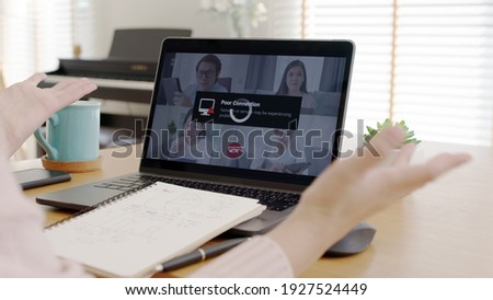 Back rear view young asian woman employee work from home using computer notebook videocall meeting conference angry annoy with low poor unreliable internet wifi connection problem issue outage. Royalty-Free Stock Photo #1927524449