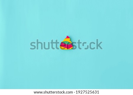 minimalism, multi-colored children's eraser on a blue background, concept