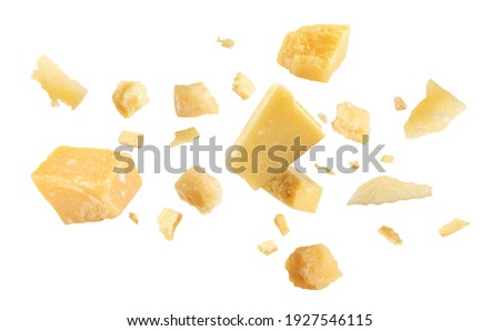 Pieces of delicious parmesan cheese flying on white background Royalty-Free Stock Photo #1927546115