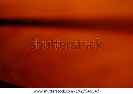 Orange and black smudged abstract background. Honey-colored