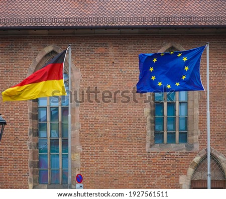 NUREMBERG, GERMANY - November 2019: The European Union and German flags outside.  town hall building on background.