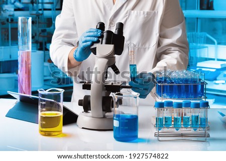Biomedical engineer at work with samples in chemistry laboratory. Chemical researcher working in research lab with material and microscope Royalty-Free Stock Photo #1927574822