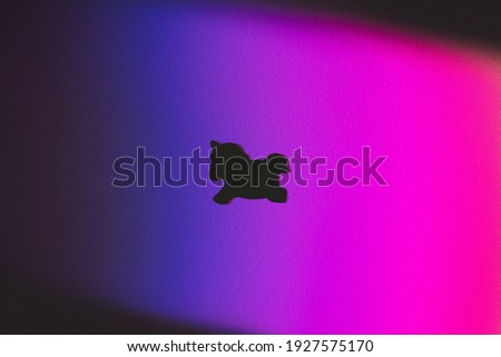 Black unicorn on textured rainbow purple and pink background