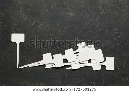 Collage of small white plastic signs on a decorative background