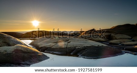 Sunset on skerries in Ytre Hvaler National Park, on the island of Kirkeoy in Norway Royalty-Free Stock Photo #1927581599