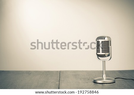 Retro microphone on table sepia photo