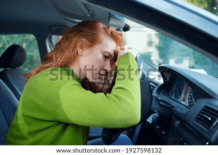 Worried woman portrait sitting and driving her car