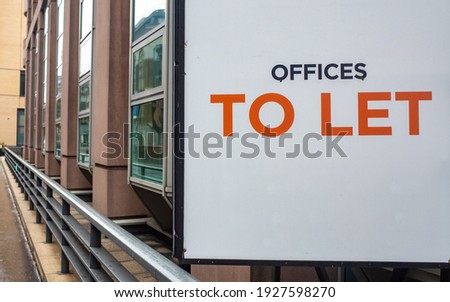 Offices To Let sign with city office building in background