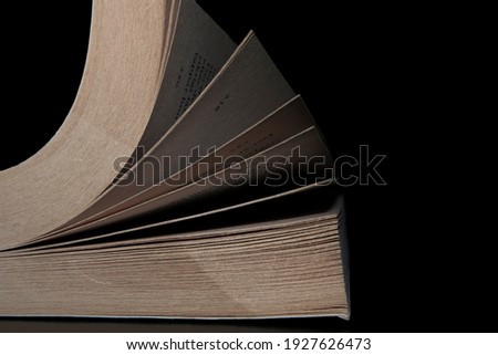 Old book on dark background reading