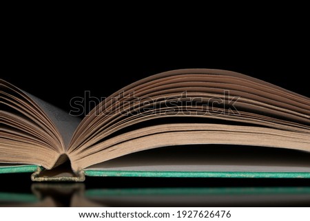 Old book on dark background reading