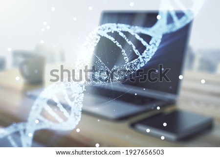 Creative concept with DNA symbol illustration and modern desktop with computer on background. Genome research concept. Multiexposure