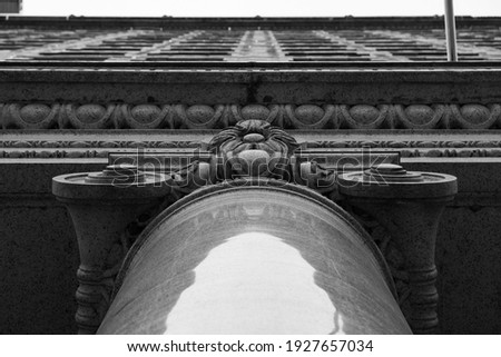 A black and white photo of architecture on the downtown city streets.