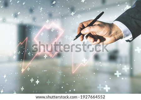 Double exposure of male hand with pen working with abstract virtual heart rate hologram on blurred interior background. Healthcare technolody concept