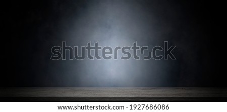 Empty wooden table with smoke float up on dark background for showing or design backdrop.