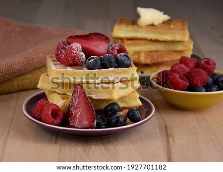 Homemade traditional belgian waffles with fresh fruits berries stock images. Fresh waffles with strawberries, raspberries and blueberries stock photo. Sweet breakfast with waffles and fruit images