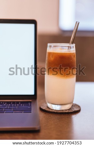 coffee and Laptop on wooden table background. use in Traditional Chinese Alphabet operating system.