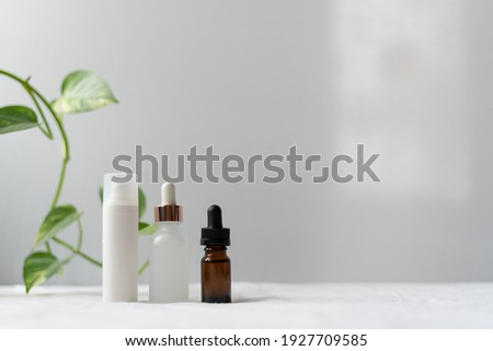 Clean and Organic skin care products on clean white cotton background and green plant leaves. Natural organic skincare, bio, healthy lifestyle concept. Minimalist, zero waste design. Copy space. Royalty-Free Stock Photo #1927709585