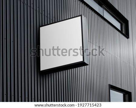 Blank White Square Store Signboard. Illuminated Lightbox on a Black Corrugated Wall Royalty-Free Stock Photo #1927715423