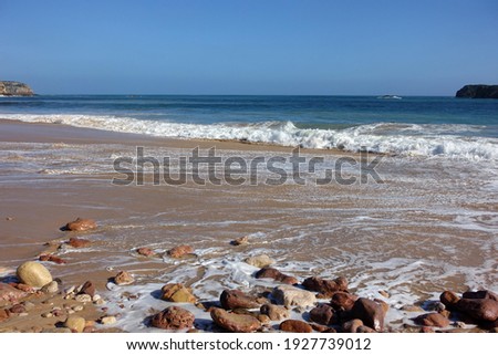 Beautiful Portuguese beach with sand, rocks and waves